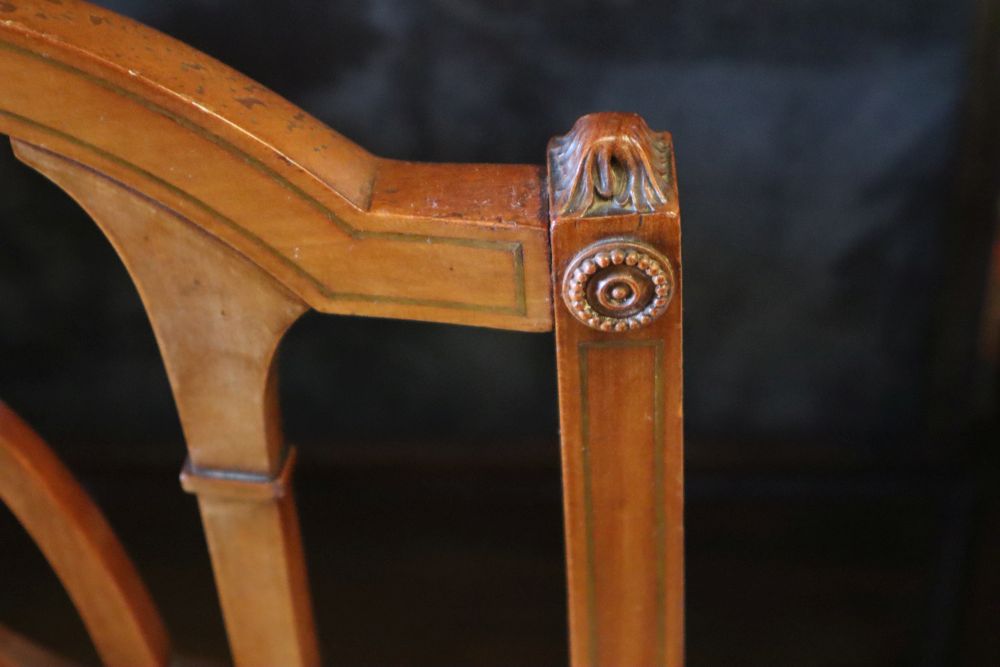 A parcel gilt satinwood centre table, width 113cm height 62cm, and a pair of Edwardian satinwood salon chairs